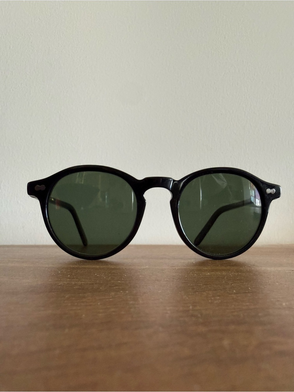 MOSCOT Black Frame Sunglasses with Green Lenses